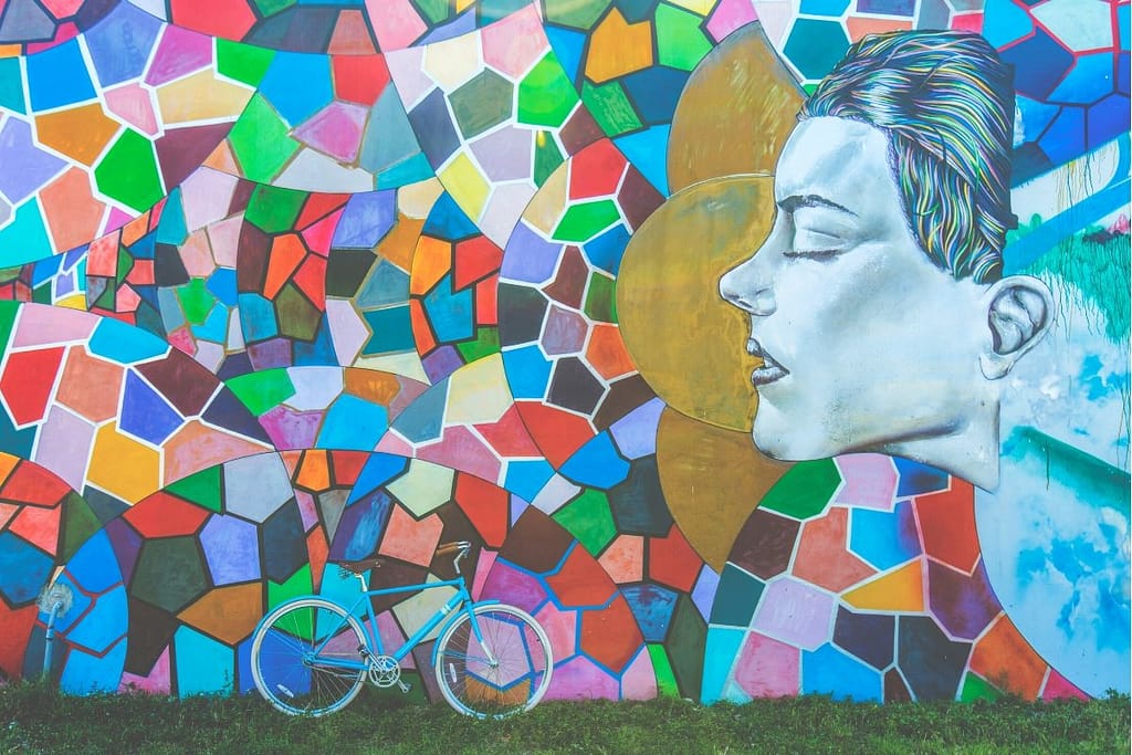 One of Venice Beaches beautiful murals, rich in mosaic colours with a bike resting against it