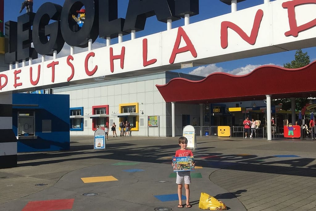 Lukas with his lego purchase outside the legoland sign