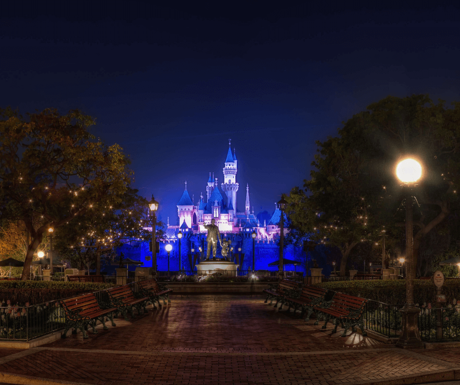 Night shot of Disney's Sleeping Beauty's Castle lit in blue