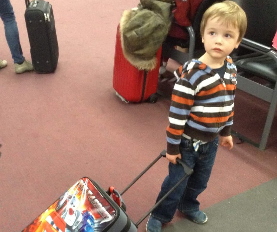 Lukas in the terminal with his suitcase