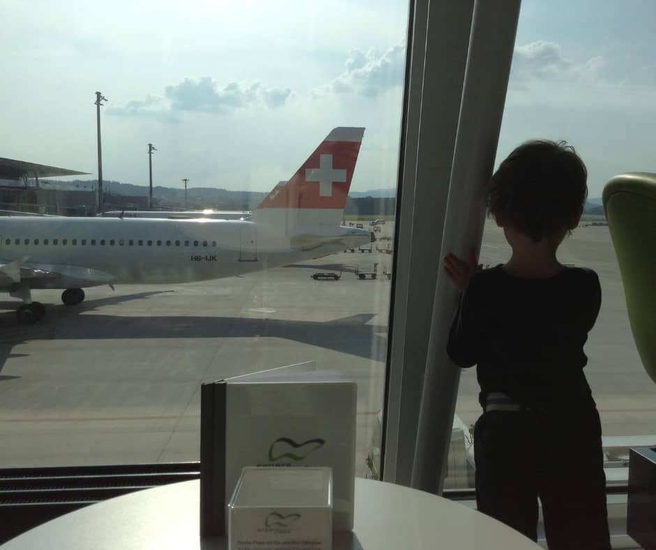 Lukas watching planes from the restaurant window in Zurich airport
