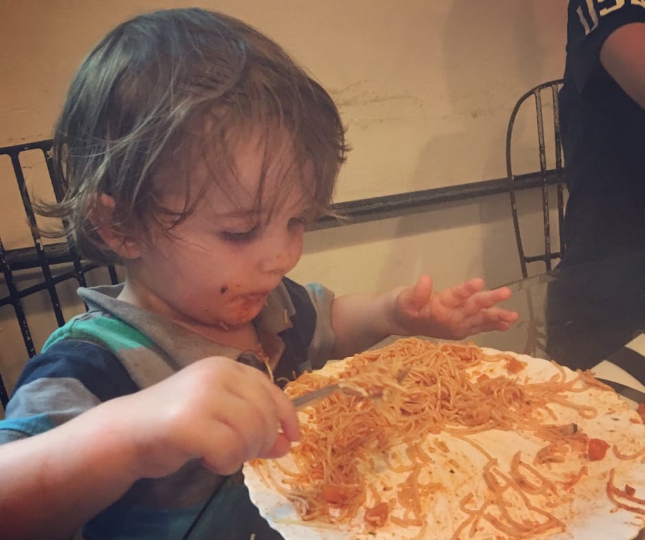 Sawyer eating pasta and being covered in pasta