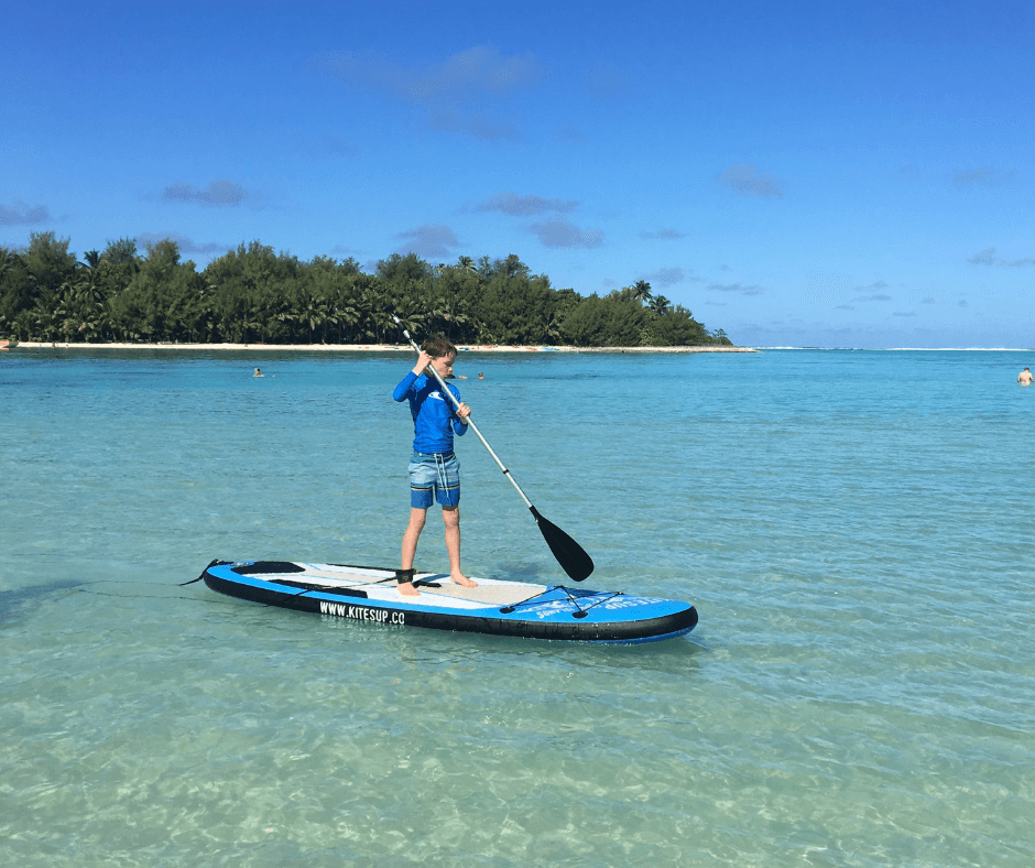 Lukas paddleboarding for his first time on Muri lagoon