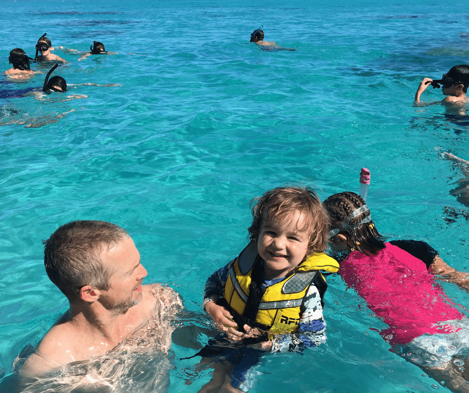 Dad and Sawyer swimming while those around snorkel on our Kota cruise
