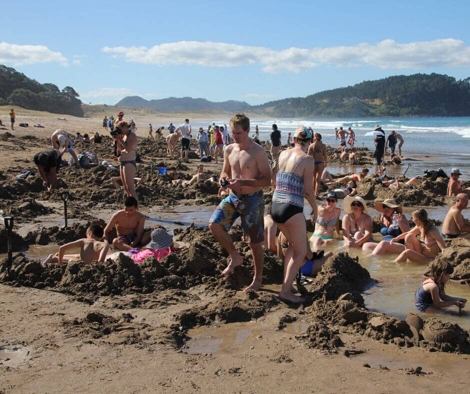 The crowds relaxing and digging their holes on Hot Water Beach, Coromandel