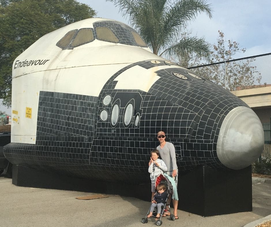 Family photo with part of the space shuttle Endeavour