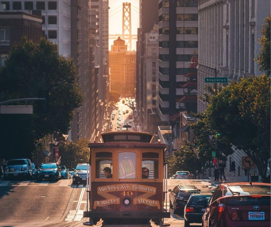 Looking down the street at the approaching Cable Car with the Golden Gate Bridge in the background