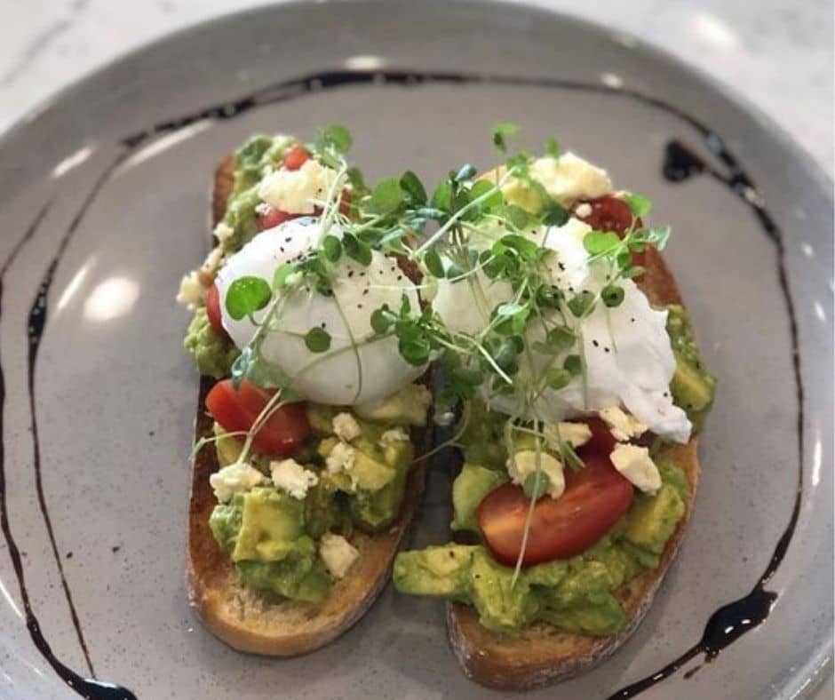 Eggs, tomatoes, on smashed avocado, great breakfast to kick off the day