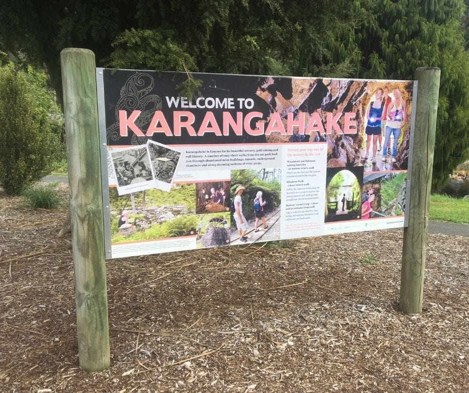 The 'Welcome to Karangahake' sign greets your before you cross the footbridge