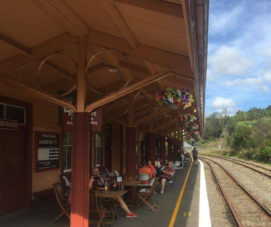 People relaxing on the platform of Waikino Station Cafe