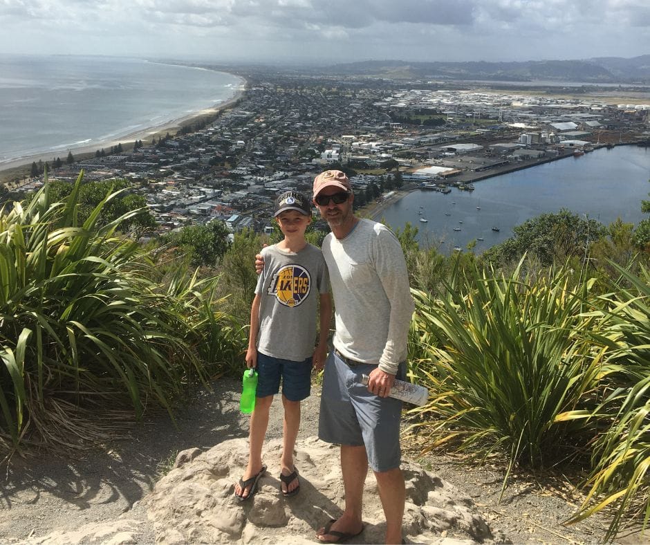 Lukas and I after climbing to the top of Mauao. Mount Maunganui in the background. This climb and view make it a must when listing things to do in Mount Maunganui