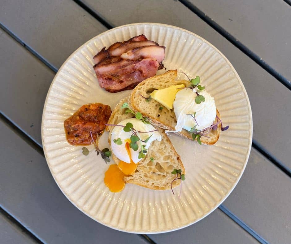Breakfast, eggs, hash brown, bacon served on sour dough bread from one of the top Papamoa Cafes