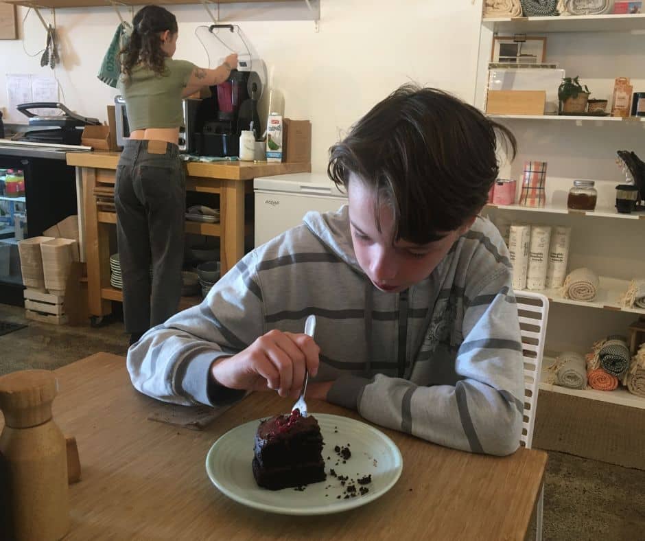 Lukas enjoying his chocolate cake,at one of Papamoa's best cafes
